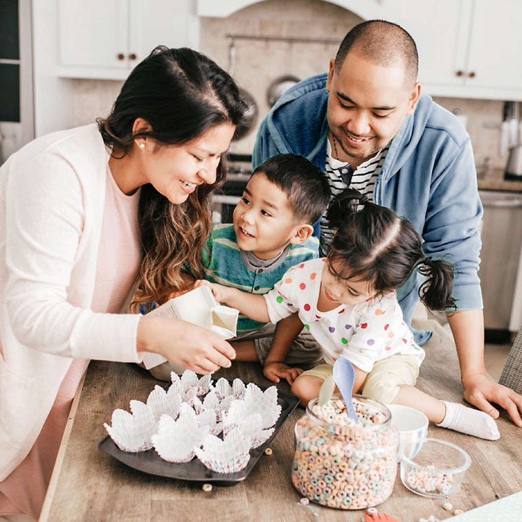 happy family of four baking together