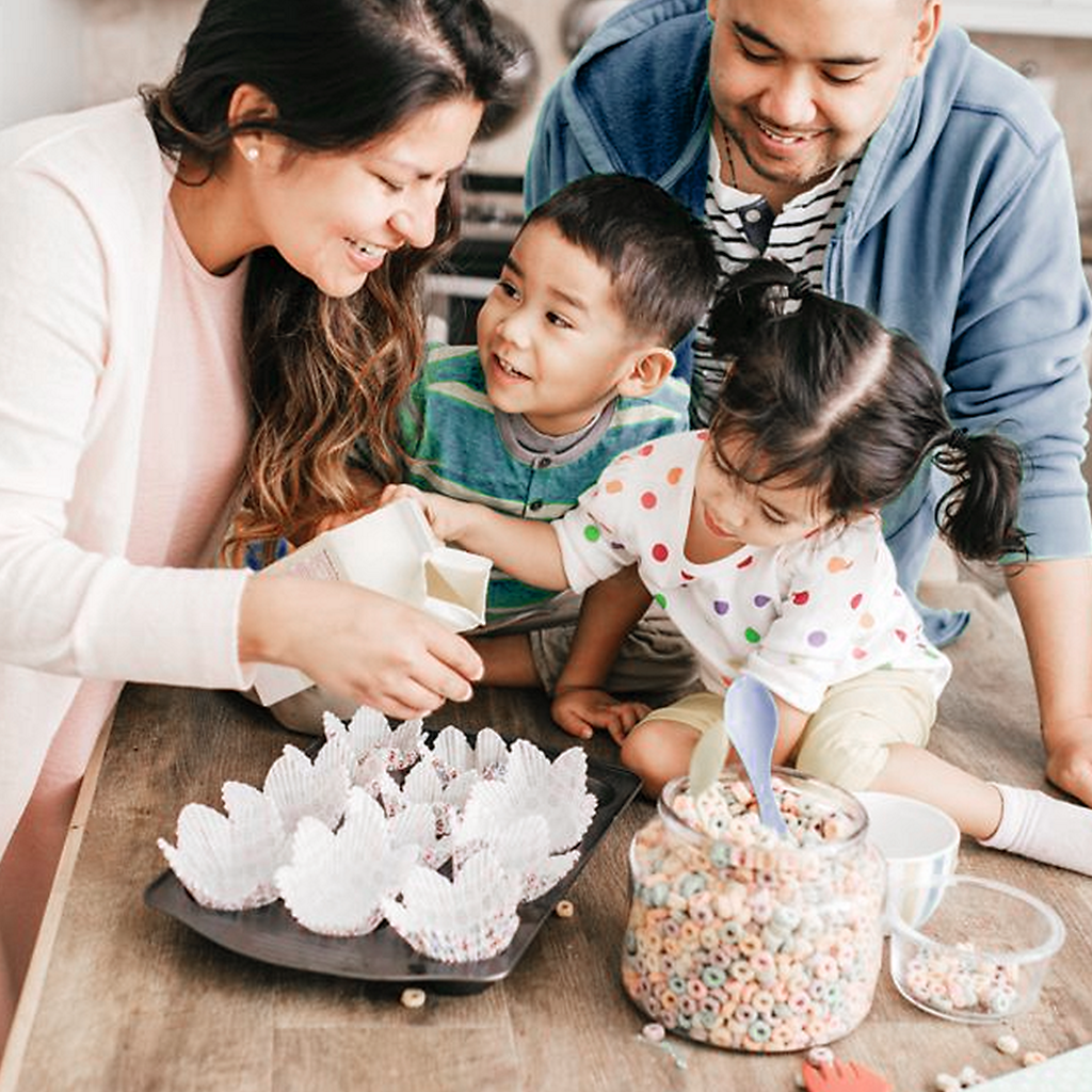 happy family of four baking together