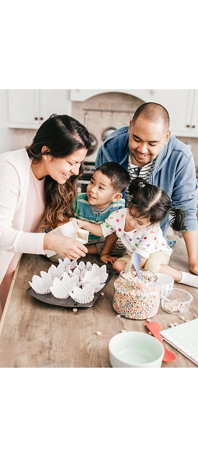 happy family of four baking together 