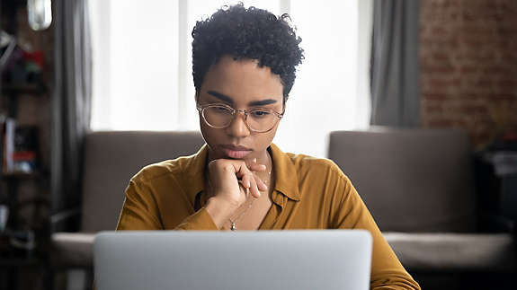 A woman looking at her laptop