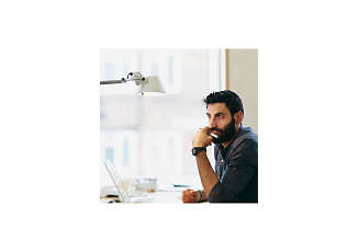 man lost in his thoughts while working at his desk