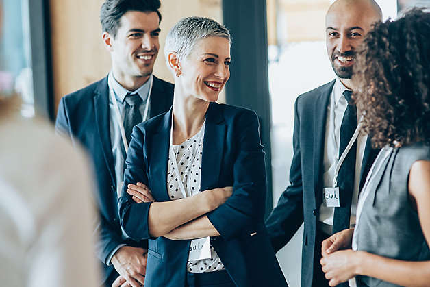 Group of adults chatting at a business event