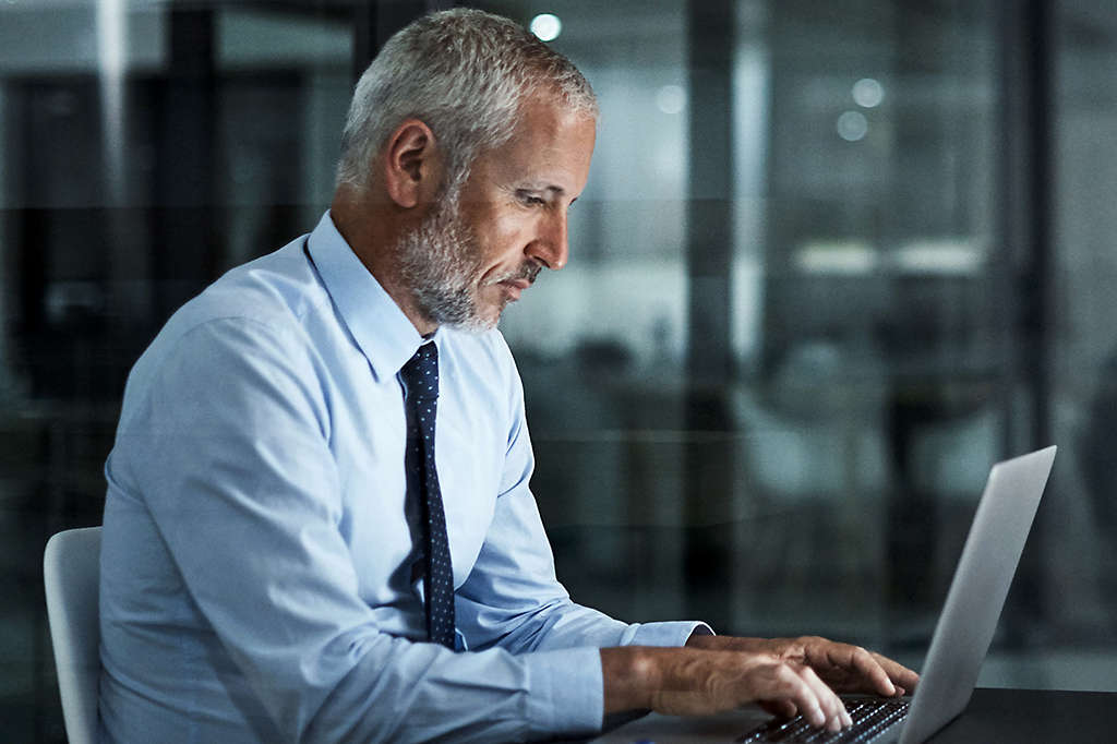 Person working on a laptop in an office setting