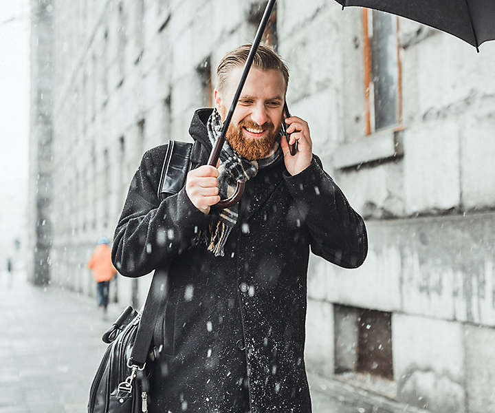 Man talking on phone in the snow