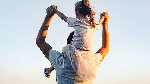 A man holding his child on his back