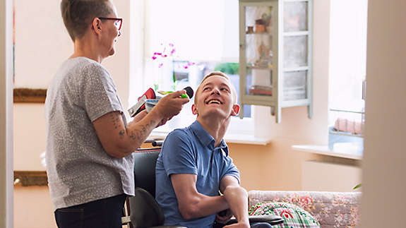 Mother helping special needs child