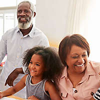 Family smiling together in their kitchen