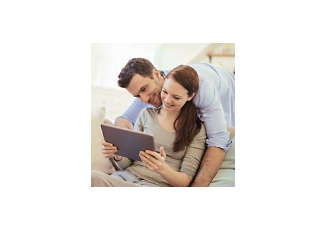 happy couple looking at tablet