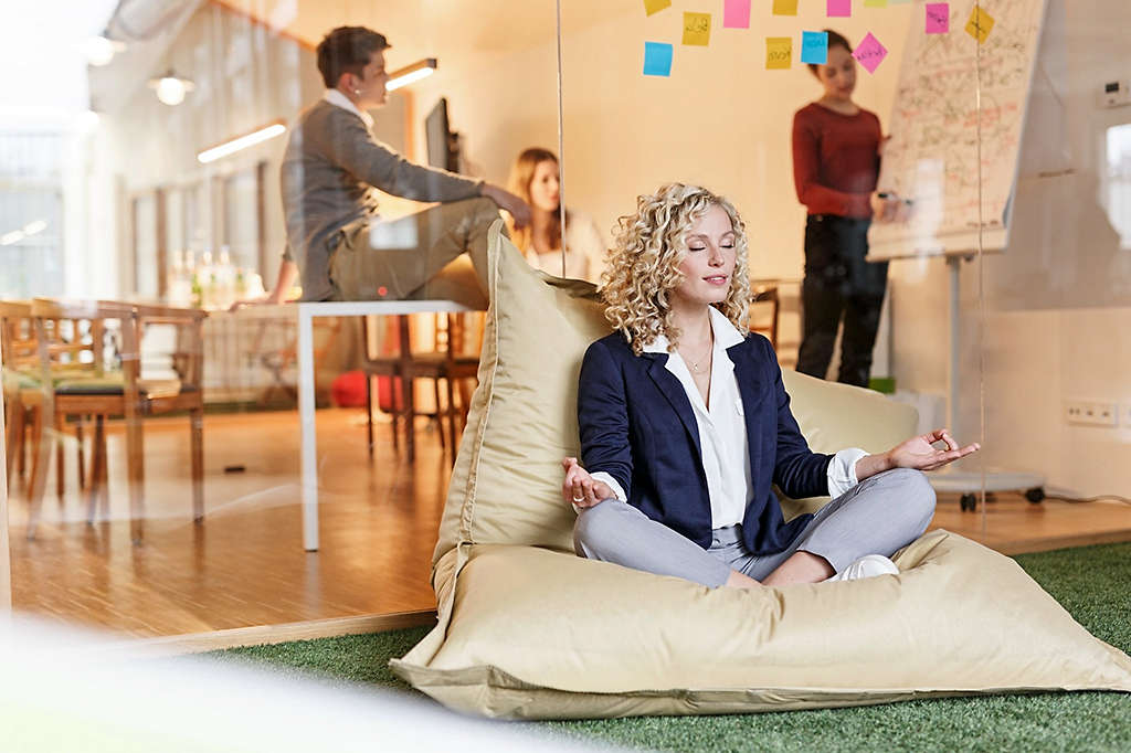 Women meditating on a pillow