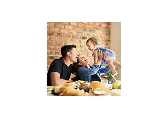 mother holding their baby up with father