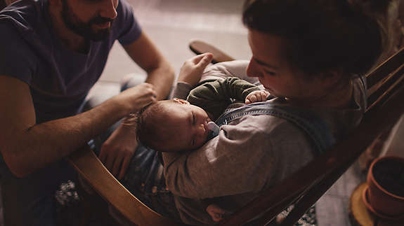 Young parents with their newborn baby