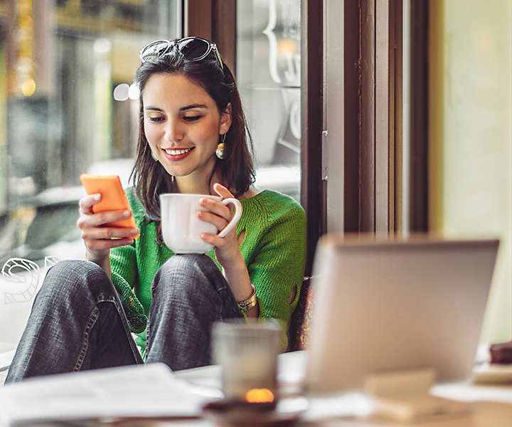 woman-on-phone-at-cafe-1x1