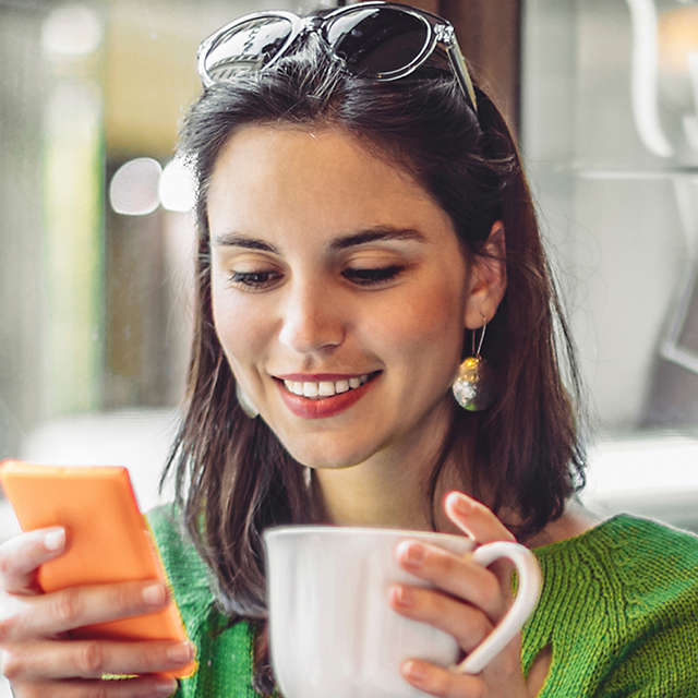 woman-on-phone-at-cafe-b-16X9