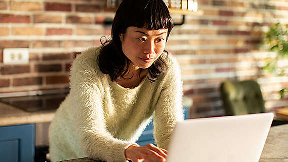 Young businesswoman working late on a computer in an office